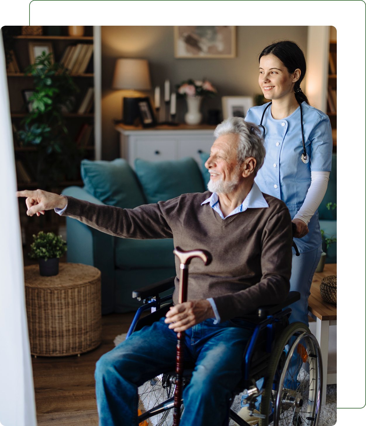 Elderly man in wheelchair with caregiver smiling.