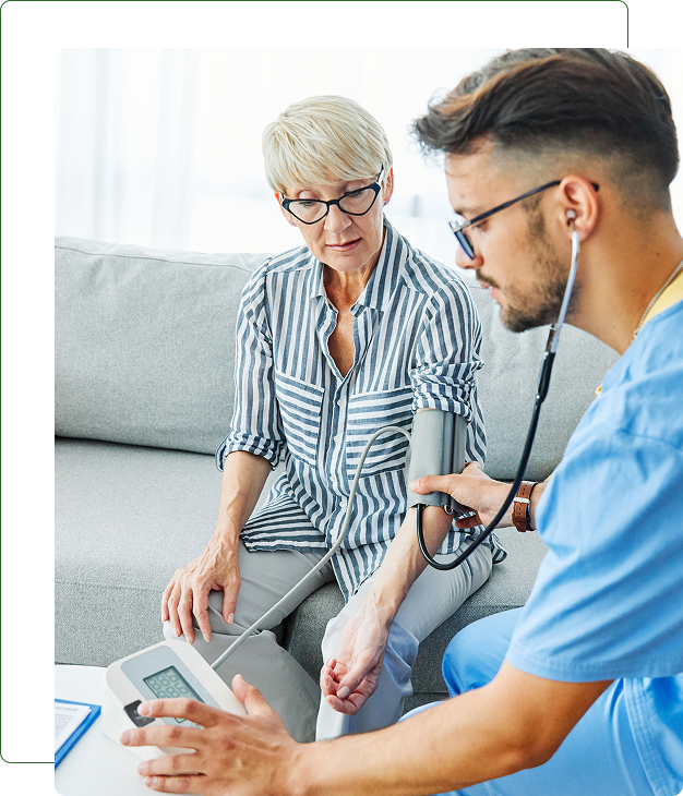 Healthcare professional checking patient's blood pressure.