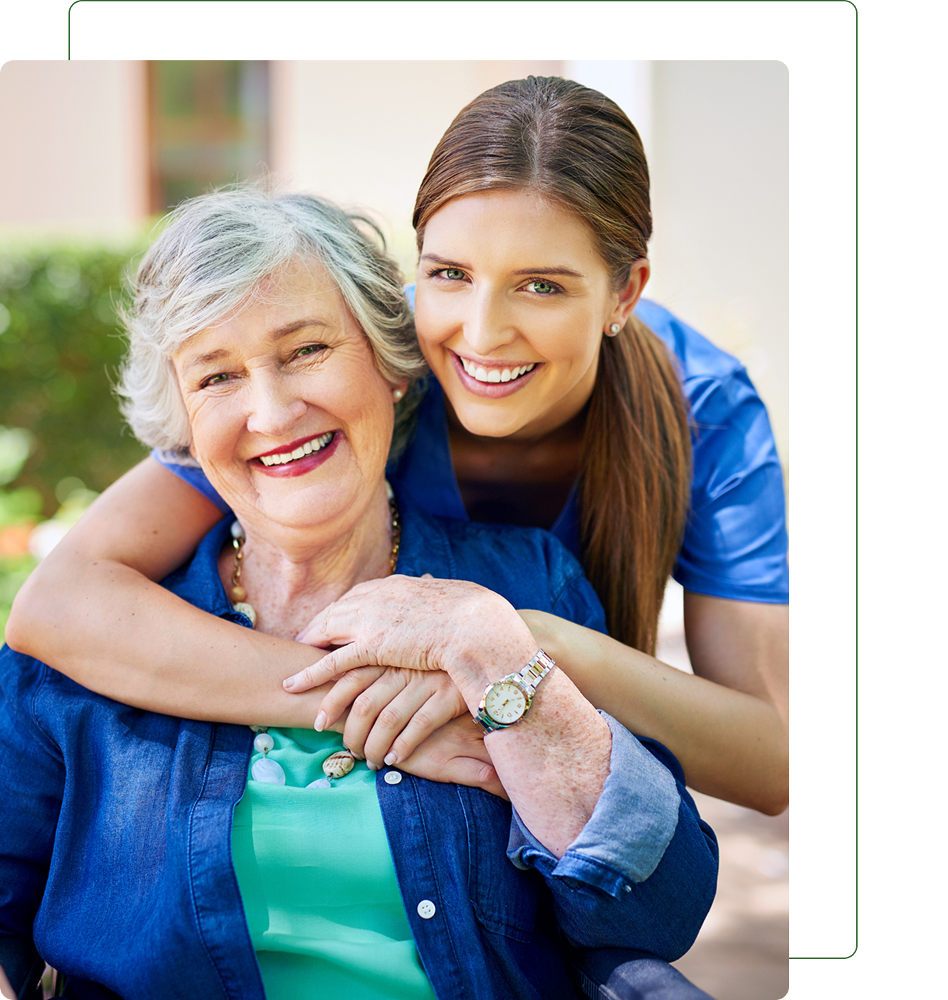 Smiling woman hugging an older woman outdoors.