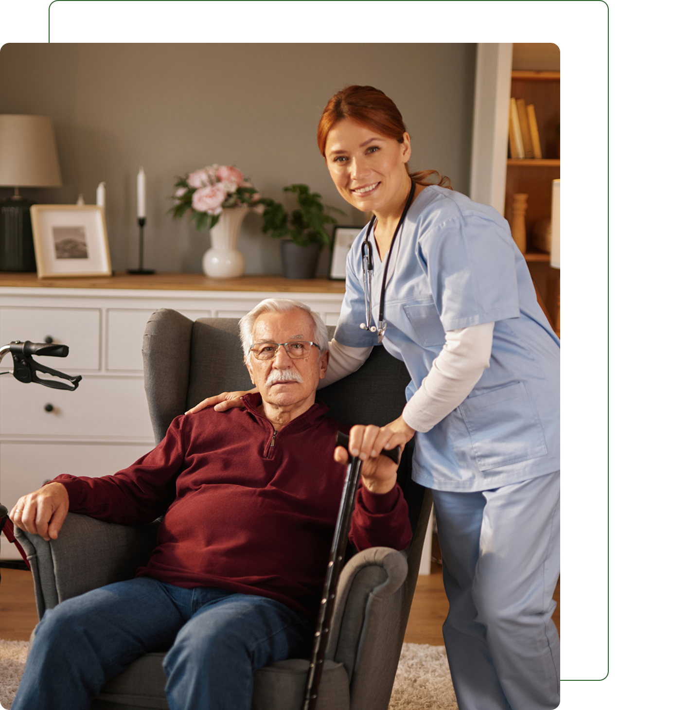 Caregiver standing beside seated elderly man.